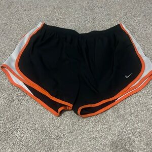 Nike Black Athletic Shorts with Orange Trim and White Side Panels